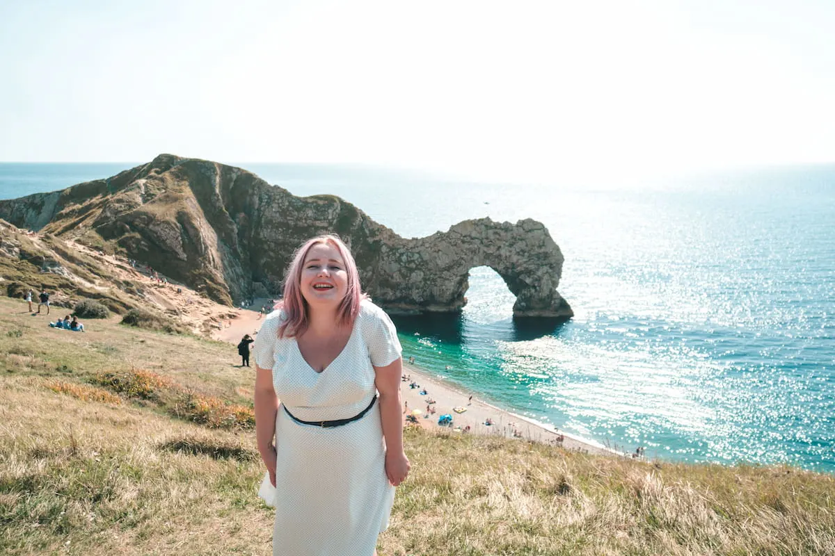 Kat in a white dress at Durdle Door