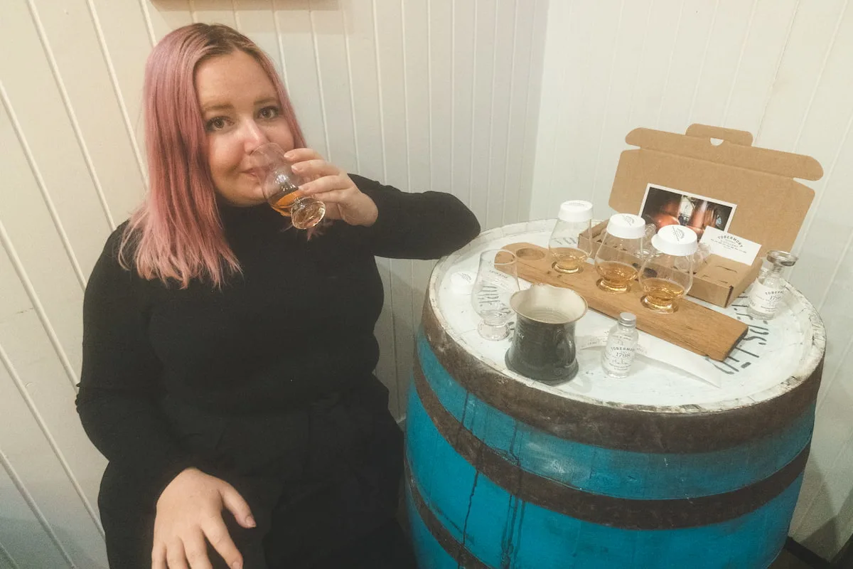 Kat drinking whisky at Tobermory