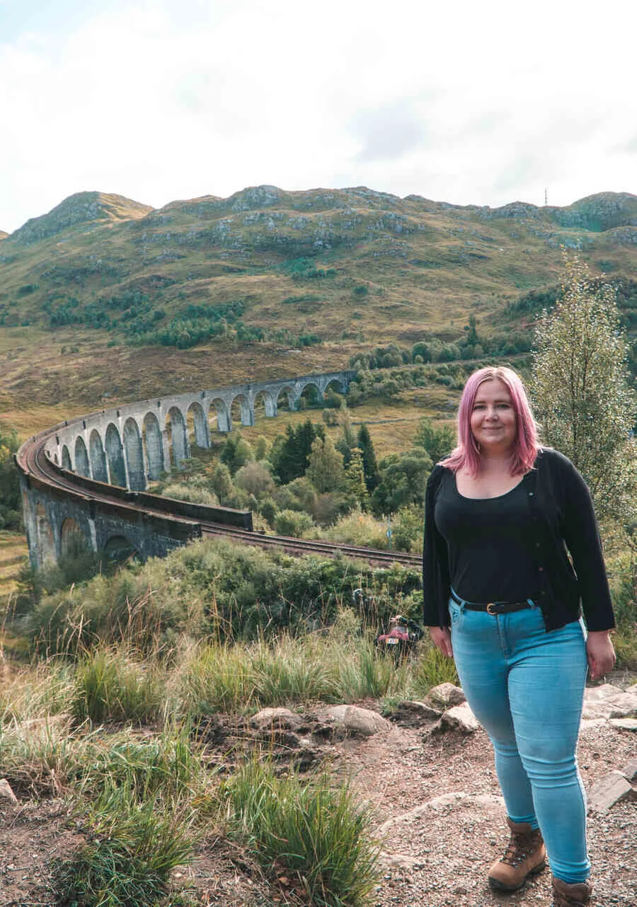 Kat in her hiking boots at Glenfinnan Viaduct Scotland