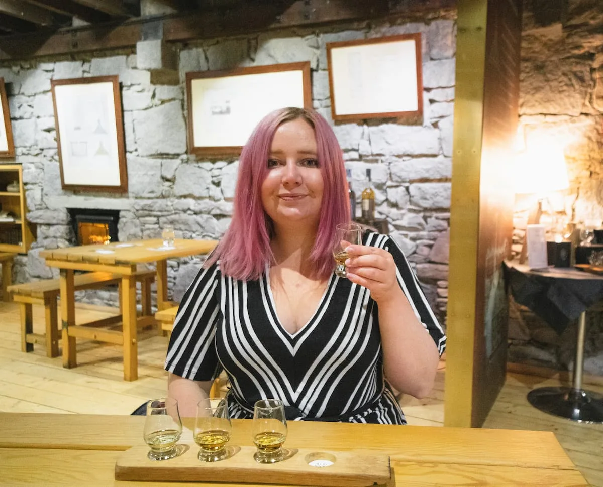 Kat drinking whisky at Oban Distillery