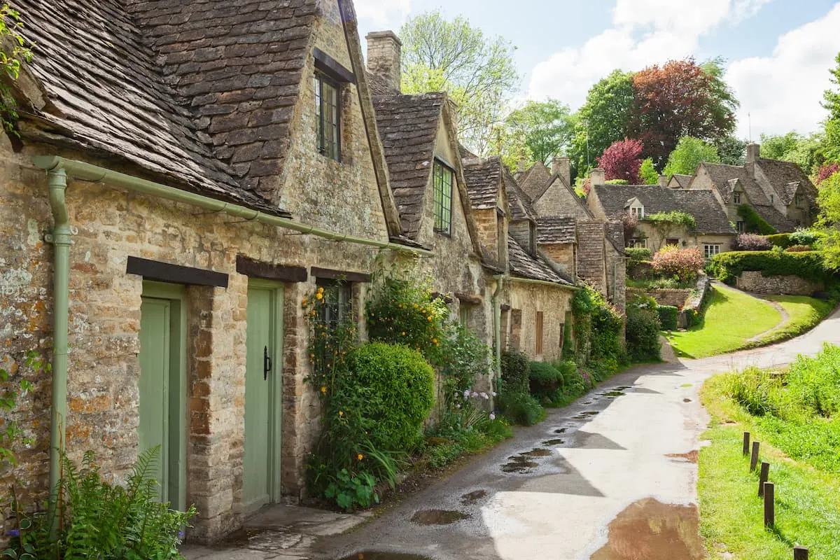 Old street with traditional cottages in beautiful spring day , Bibury