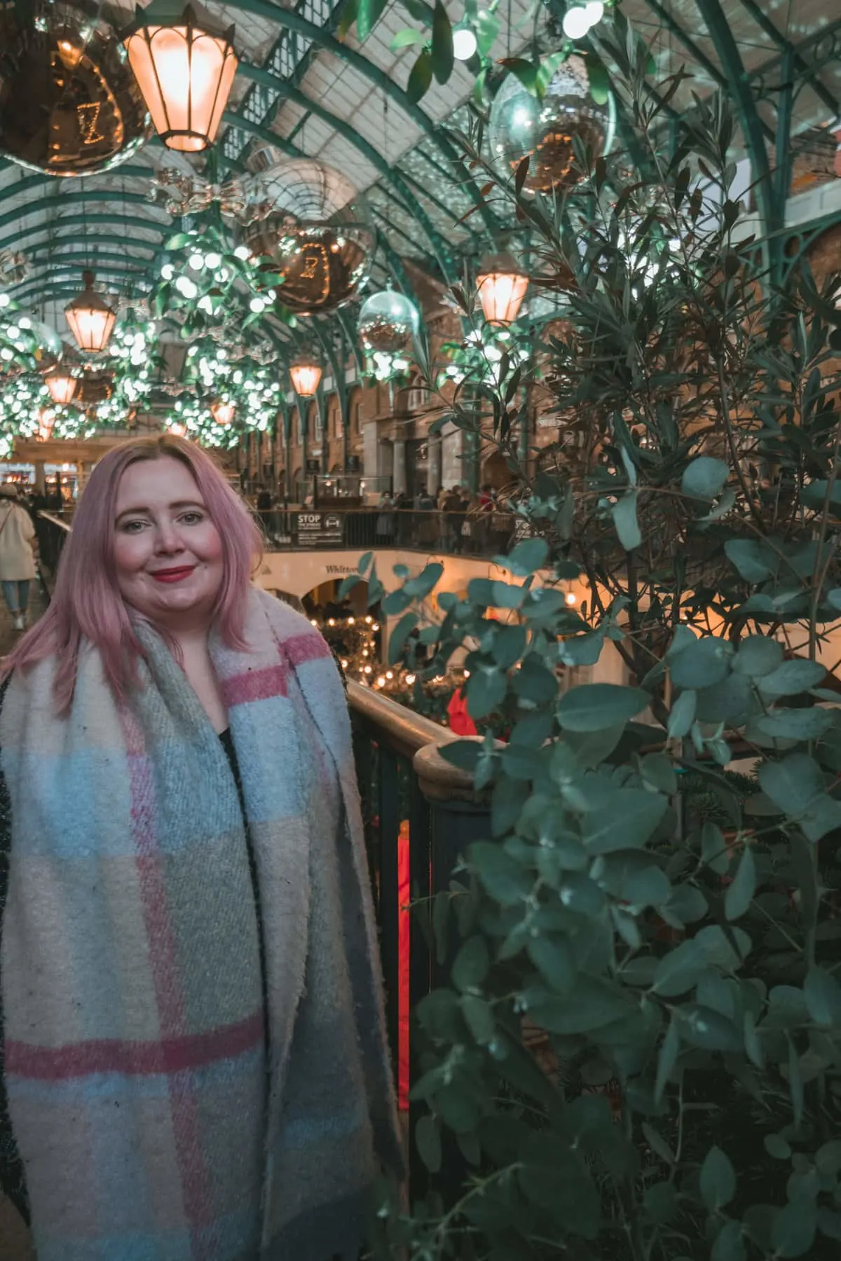 Kat standing in front of the Christmas lights in Covent Garden