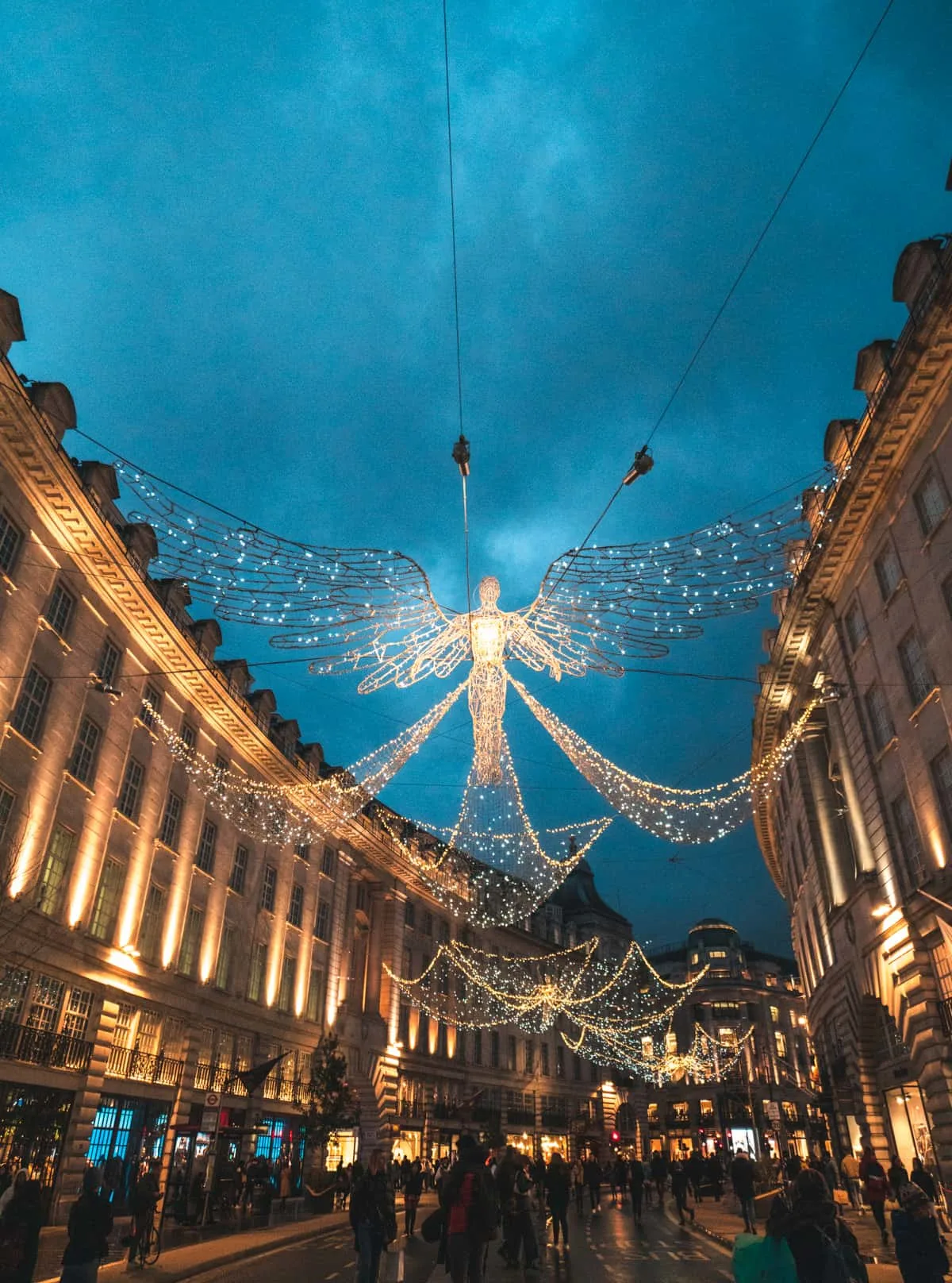 Angel lights on Regents Street with people walking by