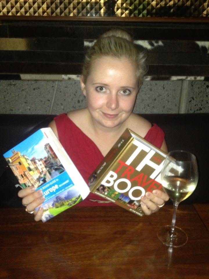 Kat in 2013, before the move, with a Rough Guide to Europe in one hand, The Travel Book in the other and a glass of wine. This is where the plan started.