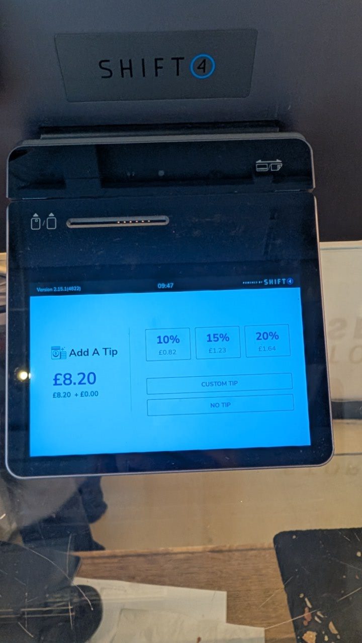 A card machine screen asking for a tip on an £8.20 sale, offering 10, 15 and 20 per cent