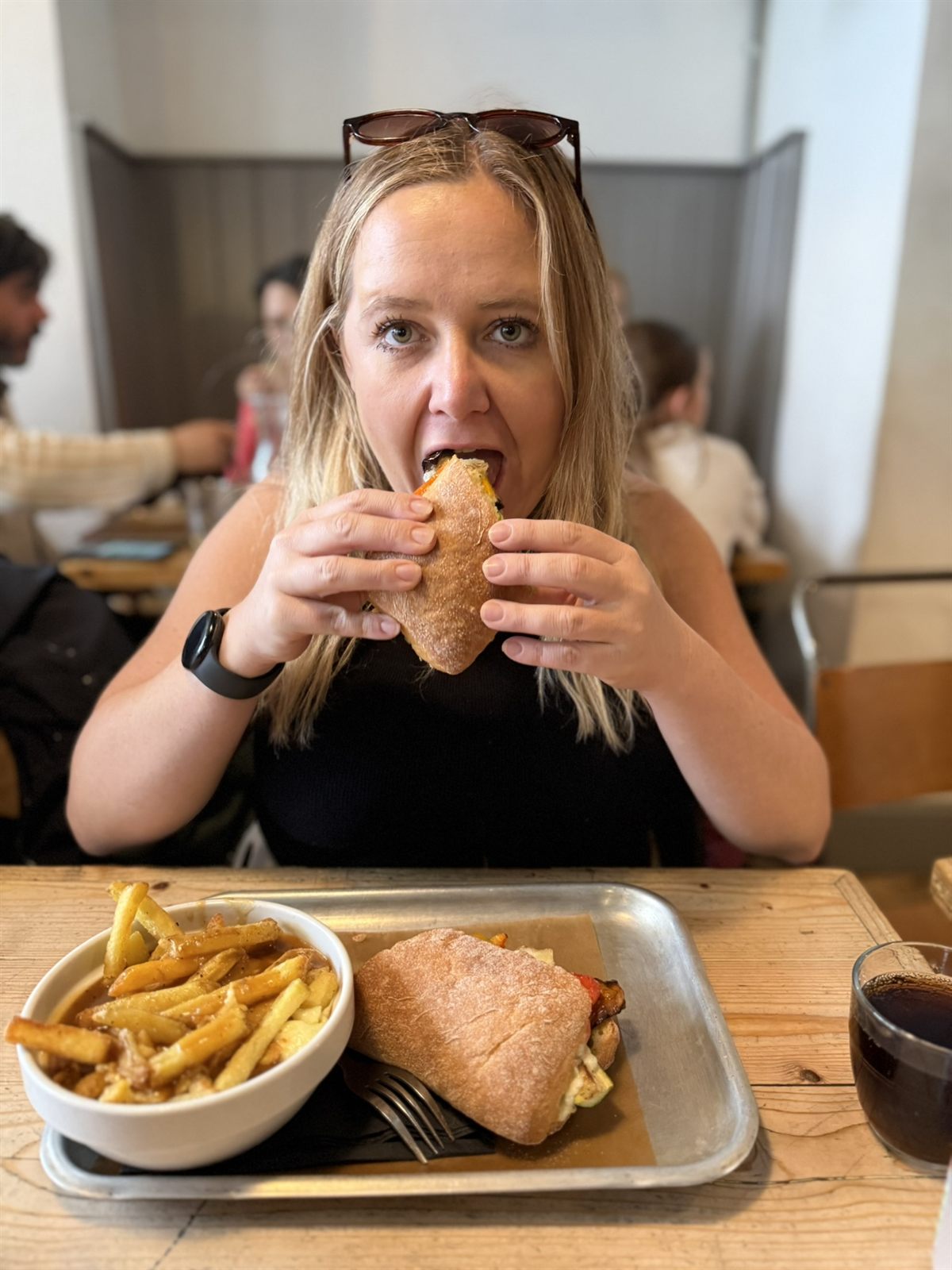 Kat with a roast vegetable ciabatta and a bowl of poutine at Bread and Meat in Cambridge