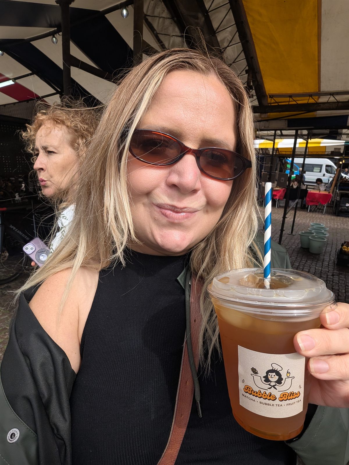 Kat holding an iced tea from the Bubble Bliss stall at Cambridge Market Square