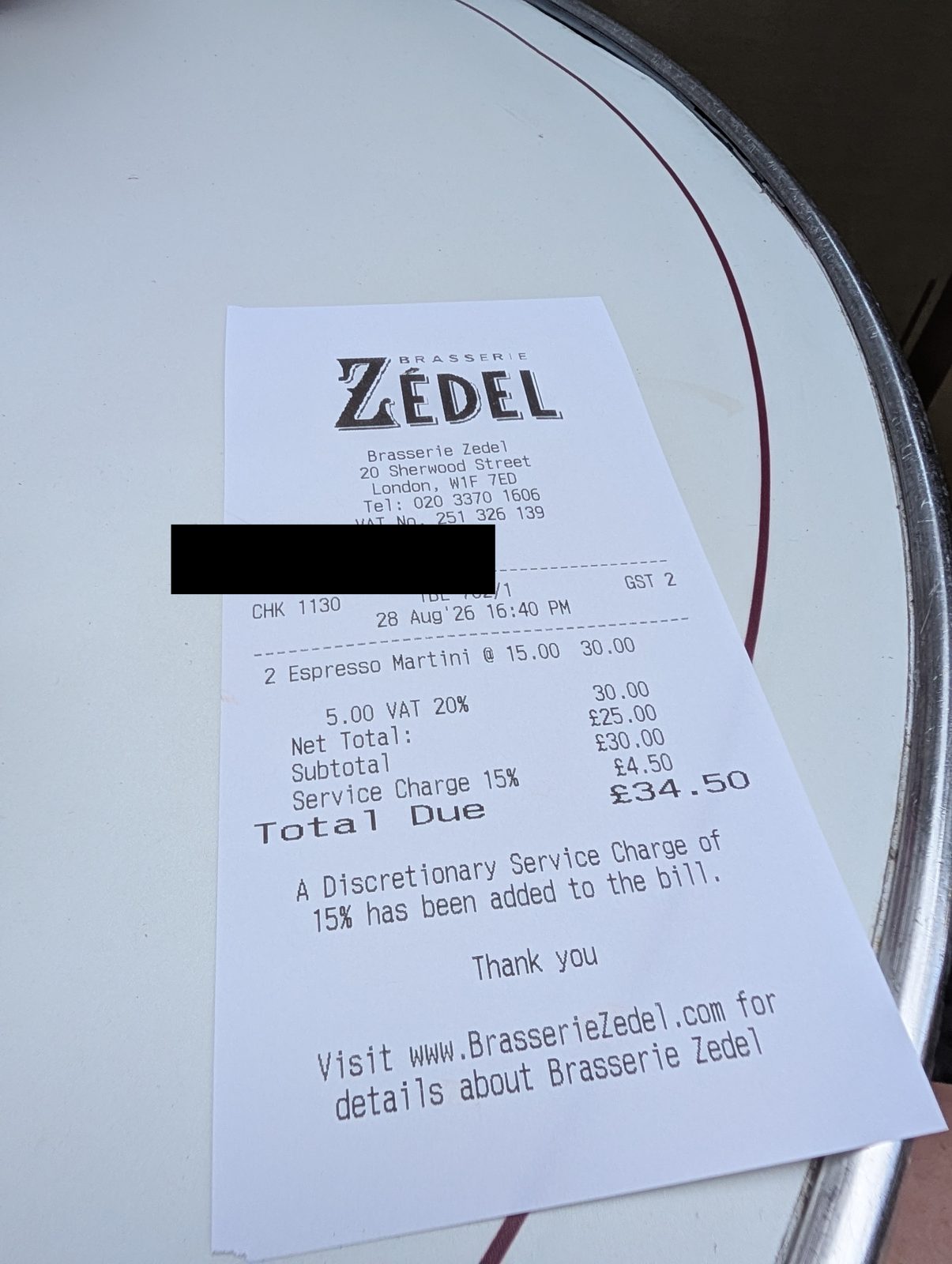 Restaurant bill showing two espresso martinis at £30 with a 15 per cent discretionary service charge added