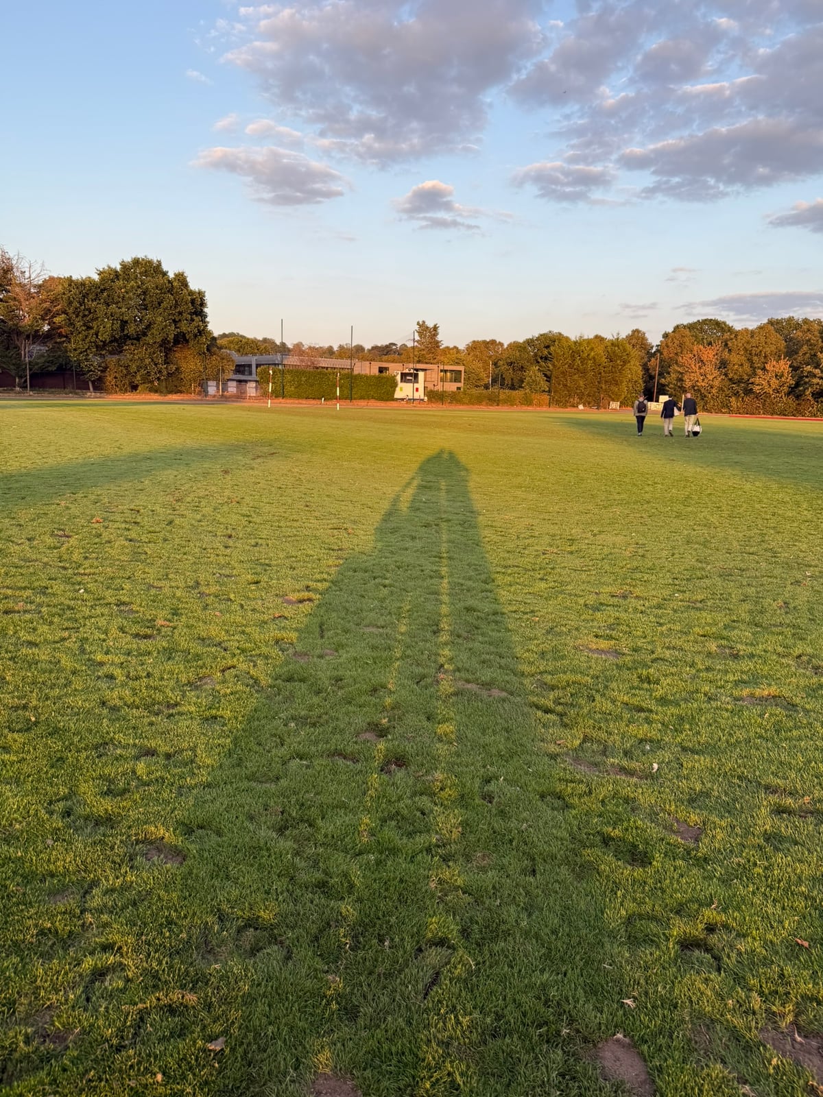 Kat's shadow across the pitch at sunset
