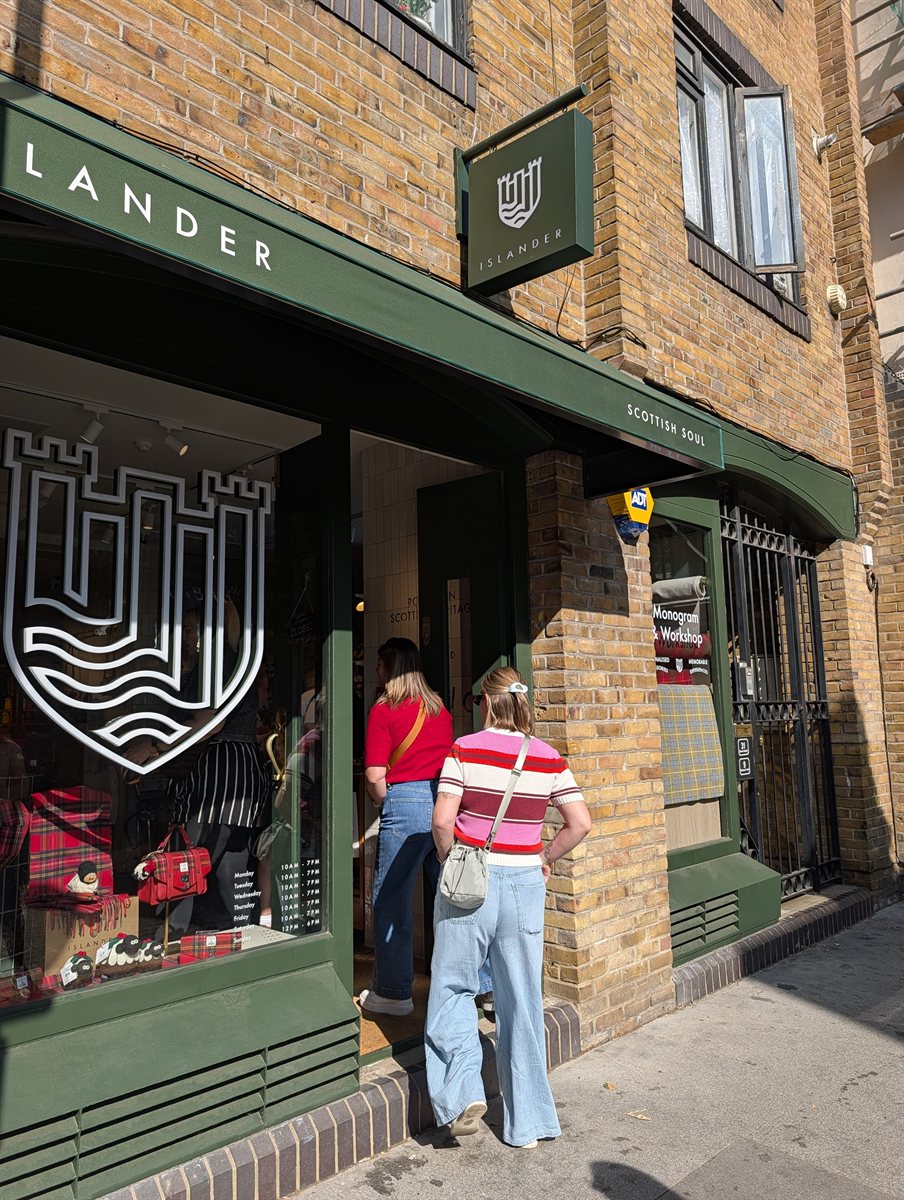 The green Islander shopfront on Shorts Gardens, Covent Garden, with its opening hours on the window
