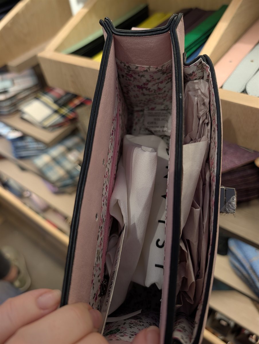 The pink and white flower print lining inside an Islander vegan bag